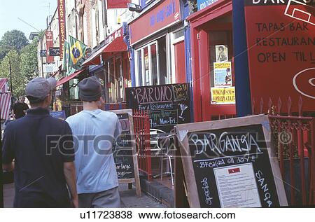 People walking past cafe Bar Ganza in Camden Town in London View Large Photo Image Stock Photo - People walking past cafe Bar Ganza in Camden Town in London. Fotosearch