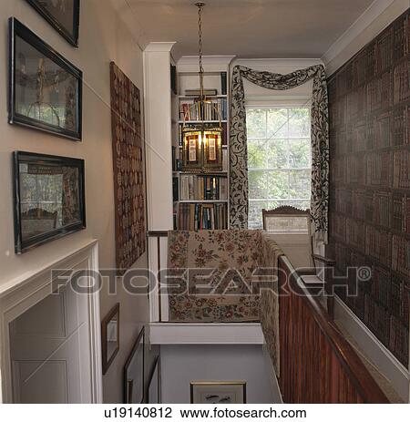 Stock Image - Pictures and carpet on walls of traditional landing. Fotosearch