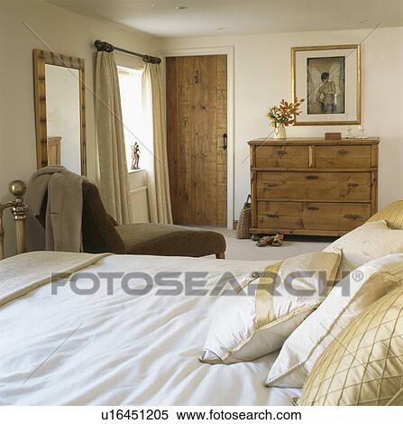 Pine chest-of-drawers in cream country bedroom View Large Photo Image Stock Photography - Pine chest-of-drawers in cream country bedroom. Fotosearch