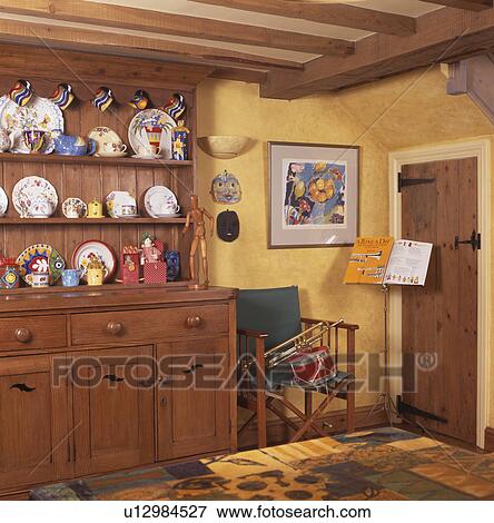 Pine dresser in yellow cottage kitchen View Large Photo Image Stock Photo - Pine dresser in yellow cottage kitchen. Fotosearch