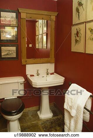 Pine mirror above white pedestal basin in red bathroom View Large Photo Image Stock Image - Pine mirror above white pedestal basin in red bathroom. Fotosearch