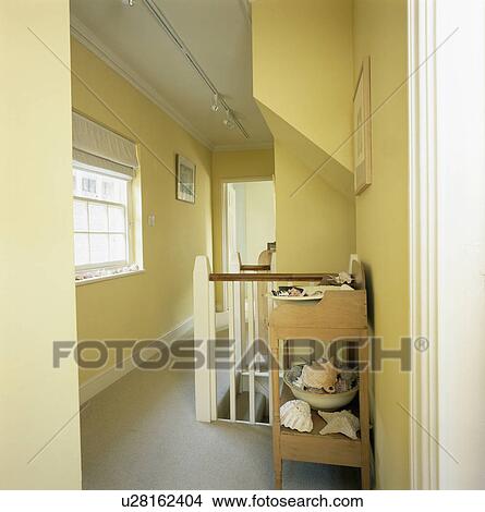 Pine wash-stand and grey carpet on yellow townhouse landing View Large Photo Image Picture - Pine wash-stand and grey carpet on yellow townhouse landing. Fotosearch