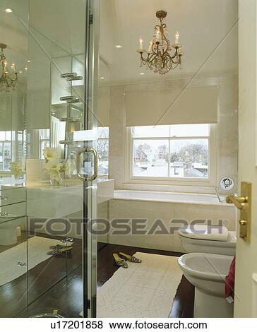 Pink chandelier in modern bathroom with mirrored wall View Large Photo Image Stock Photo - Pink chandelier in modern bathroom with mirrored wall. Fotosearch