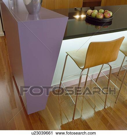 Plywood and chrome stools at mauve and black breakfast bar in modern kitchen View Large Photo Image Stock Image - Plywood and chrome stools at mauve and black breakfast bar in modern kitchen. Fotosearch
