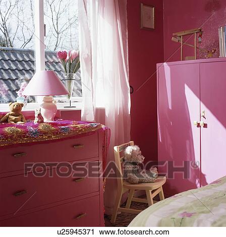 Stock Image - Pnk chest-of-drawers in pink bedroomi. Fotosearch