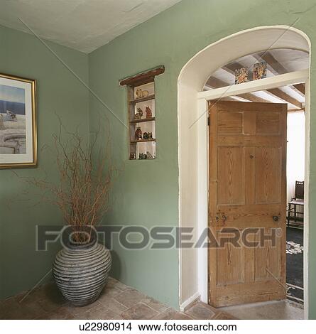 Picture - Pot of dried flowers in corner of traditional grey hall. Fotosearch