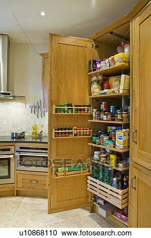 Pull Out Pantry Cupboard In Traditional Oak Kitchen Stock Image