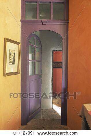 Stock Image - Purple door in orange hall. Fotosearch