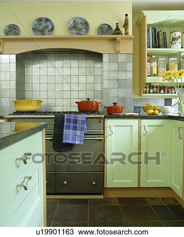Range oven in country kitchen with pale green fitted units View Large Photo Image Stock Image - Range oven in country kitchen with pale green fitted units. Fotosearch