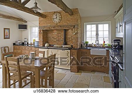 Reclaimed Antique Stone Flooring And Wooden Table And Chairs In