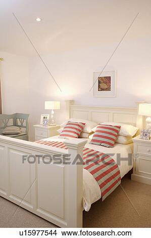 Red and grey cushions striped cushions and throw on white wooden bed in modern white bedroom View Large Photo Image Picture - Red and grey cushions striped cushions and throw on white wooden bed in modern white bedroom. Fotosearch