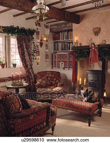 Red armchairs and stool in cottage living room decorated for Christmas View Large Photo Image Stock Image - Red armchairs and stool in cottage living room decorated for Christmas. Fotosearch