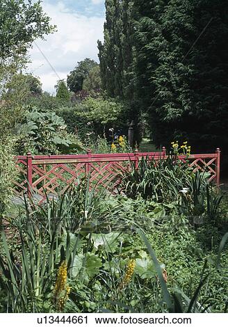 Red bridge in large country garden View Large Photo Image Stock Image - Red bridge in large country garden. Fotosearch