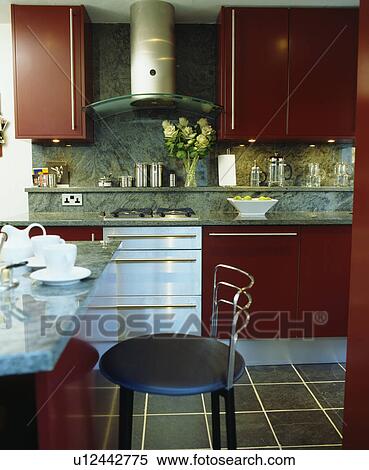 Red fitted units in modern townhouse kitchen View Large Photo Image Stock Photography - Red fitted units in modern townhouse kitchen. Fotosearch