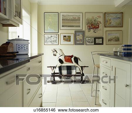 Rocking horse in modern white kitchen View Large Photo Image Stock Photograph - Rocking horse in modern white kitchen. Fotosearch