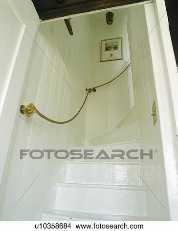 Rope handrail on wall above painted white cottage stairs View Large Photo Image Picture - Rope handrail on wall above painted white cottage stairs. Fotosearch