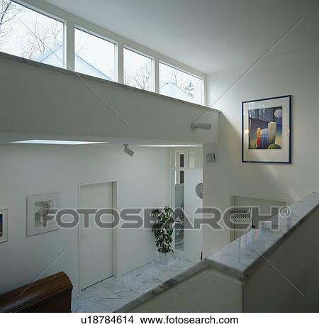 Row of windows in modern white hall viewed from landing View Large Photo Image Picture - Row of windows in modern white hall viewed from landing. Fotosearch
