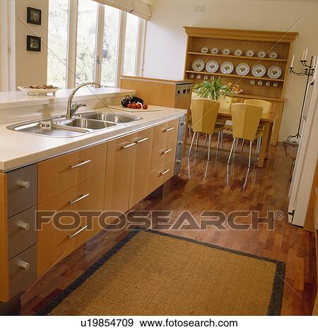 Rug on wooden flooring in modern kitchen dining room View Large Photo Image Stock Photo - Rug on wooden flooring in modern kitchen dining room. Fotosearch