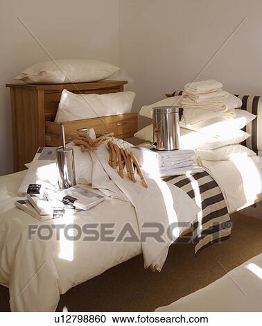 sheets in cellophane wrapping on bed with pile of white pillows in modern bedroom View Large Photo Image Stock Image - sheets in cellophane wrapping on bed with pile of white pillows in modern bedroom. Fotosearch
