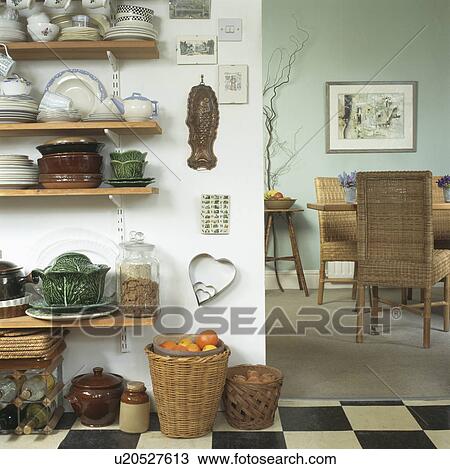 Stock Image - Shelves above baskets on worktop in traditional townhouse kitchen dining room. Fotosearch