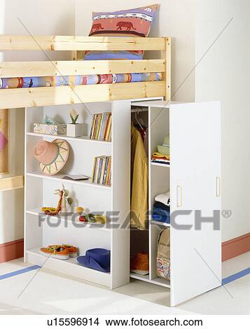 Picture - Shelving and pull-out clothes storage below platform bed in child's bedroom. Fotosearch