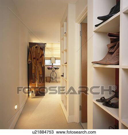 Shoes on shelves on townhouse landing with cream carpet View Large Photo Image Stock Image - Shoes on shelves on townhouse landing with cream carpet. Fotosearch