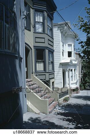 Stock Photo - Sideways view of traditional houses in American city. Fotosearch