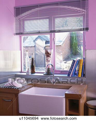 Picture - Slatted blind on window above Belfast sink in modern mauve kitchen&#10; &#10;. Fotosearch