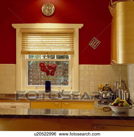 Slatted wooden blind on window in red kitchen with cream wall tiles View Large Photo Image Stock Photograph - Slatted wooden blind on window in red kitchen with cream wall tiles. Fotosearch