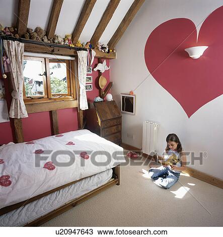 Small girl in child's country cottage bedroom with red heart painted on wall View Large Photo Image Stock Image - Small girl in child's country cottage bedroom with red heart painted on wall. Fotosearch