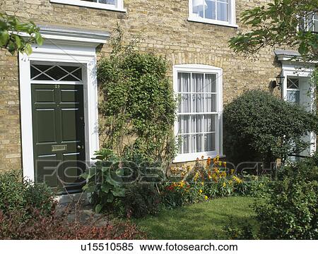 Stock Photography - Small lawn and wallflowers in border of traditional new-build terraced town-house. Fotosearch