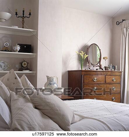 Stock Photography - Small traditional cream bedroom. Fotosearch