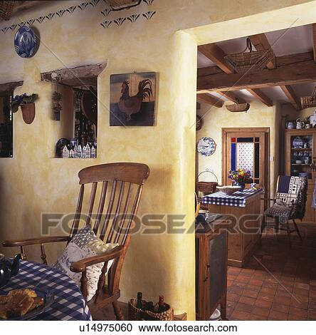Spongeing paint-effect walls in cottage dining room with old chair beside doorway View Large Photo Image Stock Image - Spongeing paint-effect walls in cottage dining room with old chair beside doorway. Fotosearch