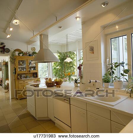 Spotlights On Ceiling Tracks In Modern White Kitchen With Double White Sinks Stock Image