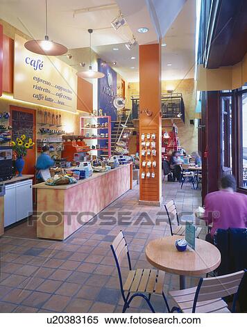 Staff behind counter and customers at tables in city cafe View Large Photo Image Stock Photography - Staff behind counter and customers at tables in city cafe. Fotosearch