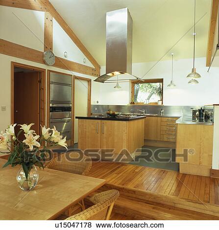 Stock Photo - Stainless steel extractor above island unit in modern kitchen. Fotosearch