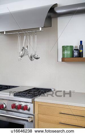 Stainless steel utensils on rack above stainless steel range oven in modern kitchen View Large Photo Image Stock Photo - Stainless steel utensils on rack above stainless steel range oven in modern kitchen. Fotosearch