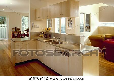 Stainless-steel worktops on pale wood units in modern open-plan kitfchen View Large Photo Image Stock Image - Stainless-steel worktops on pale wood units in modern open-plan kitfchen . Fotosearch