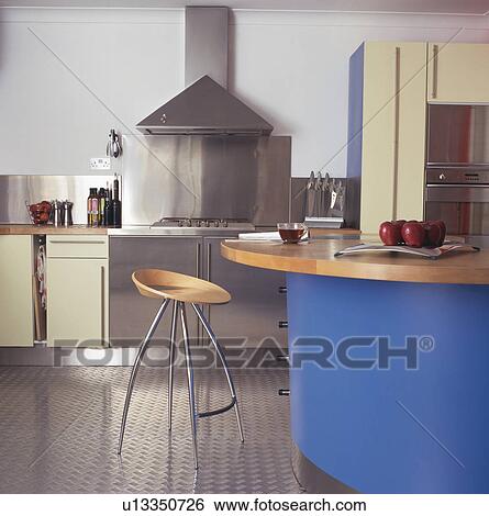 Steel and wood stool at blue breakfast bar in modern kitchen View Large Photo Image Stock Photograph - Steel and wood stool at blue breakfast bar in modern kitchen. Fotosearch