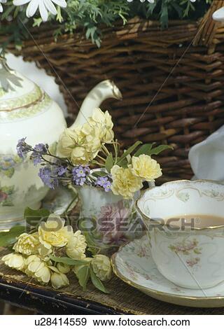 Still-Life of antique tea cup and teapot with pale yellow roses in china jug View Large Photo Image Stock Photo - Still-Life of antique tea cup and teapot with pale yellow roses in china jug. Fotosearch