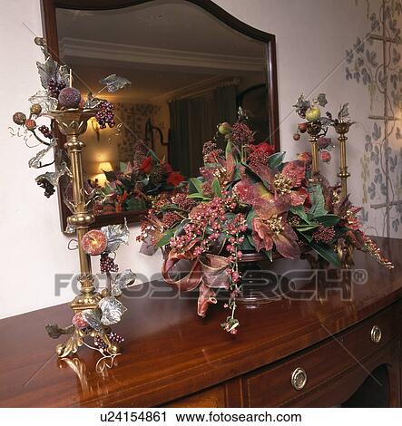 Still-Life of Autumn leaves and berries in floral arrangement on table with tall gilt candlesticks View Large Photo Image Stock Image - Still-Life of Autumn leaves and berries in floral arrangement on table with tall gilt candlesticks. Fotosearch