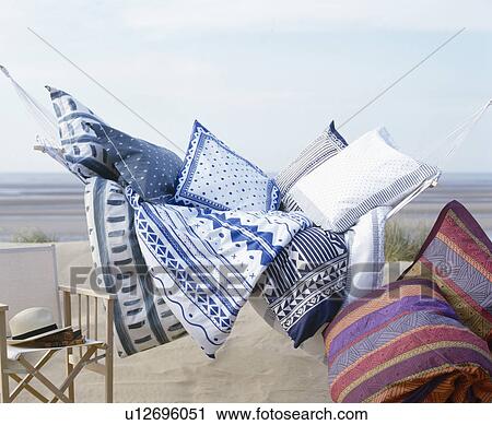 Still-life of blue+white cushions with colourful striped cushions on hammock by the beach View Large Photo Image Stock Image - Still-life of blue+white cushions with colourful striped cushions on hammock by the beach. Fotosearch