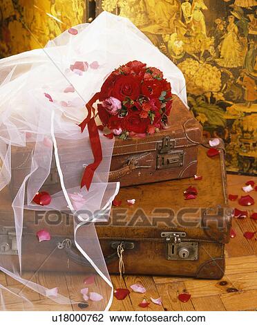 Still-Life of bridal wreath with bouquet of red roses on old leather suitcases View Large Photo Image Stock Image - Still-Life of bridal wreath with bouquet of red roses on old leather suitcases. Fotosearch
