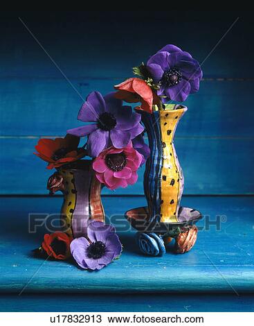 Stock Image - Still-Life of colourful anemones in pottery vases. Fotosearch