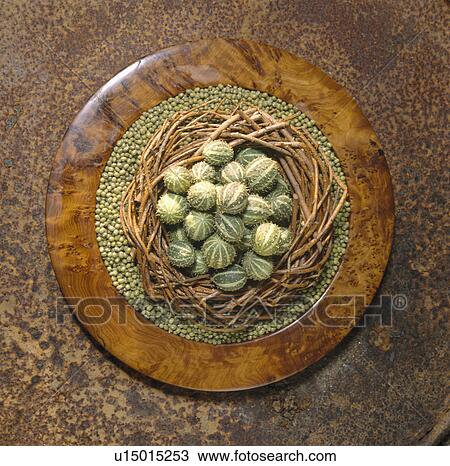Still-Life of green fruit in wicker wreath on circular wood plate View Large Photo Image Stock Image - Still-Life of green fruit in wicker wreath on circular wood plate. Fotosearch