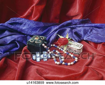 Still-Life of jewellery and blue silk scarf on red velvet fabric View Large Photo Image Stock Photo - Still-Life of jewellery and blue silk scarf on red velvet fabric. Fotosearch