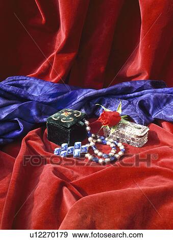 Still-Life of jewellery on red velvet fabric View Large Photo Image Stock Photo - Still-Life of jewellery on red velvet fabric. Fotosearch