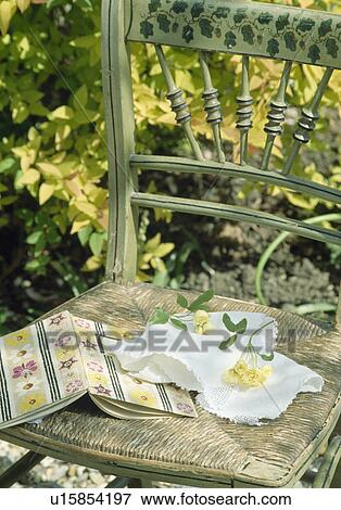 Stock Photo - Still-Life of old book and lace handkerchief on antique chair. Fotosearch