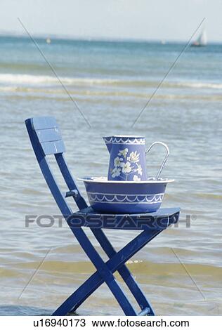 Still-Life of painted blue+white jug and bowl on blue chair beside the sea View Large Photo Image Stock Image - Still-Life of painted blue+white jug and bowl on blue chair beside the sea. Fotosearch
