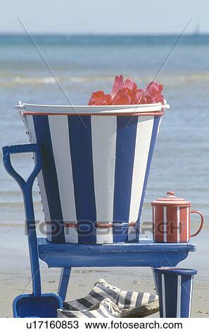 Still-Life of painted blue+white striped bucket on blue chair on beach View Large Photo Image Stock Image - Still-Life of painted blue+white striped bucket on blue chair on beach. Fotosearch
